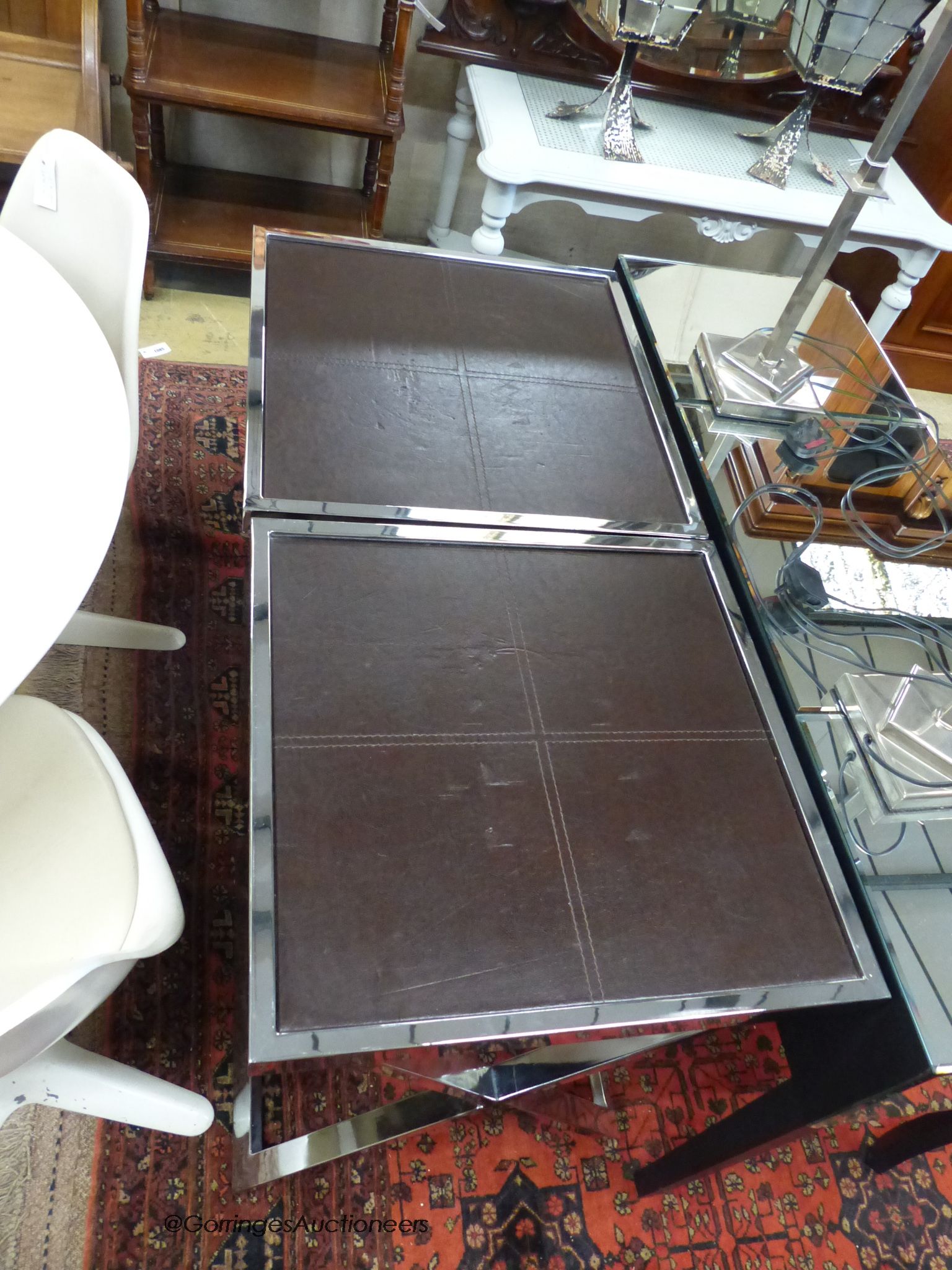 A pair of chrome and leather X-frame lamp tables by Andrew Martin, width 55cm, depth 55cm, height 74cm